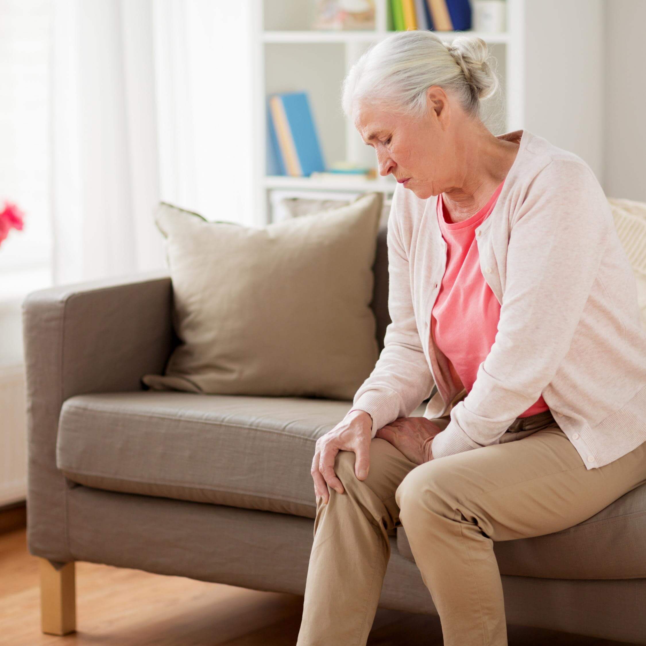 Mujer de edad tocandose la rodilla